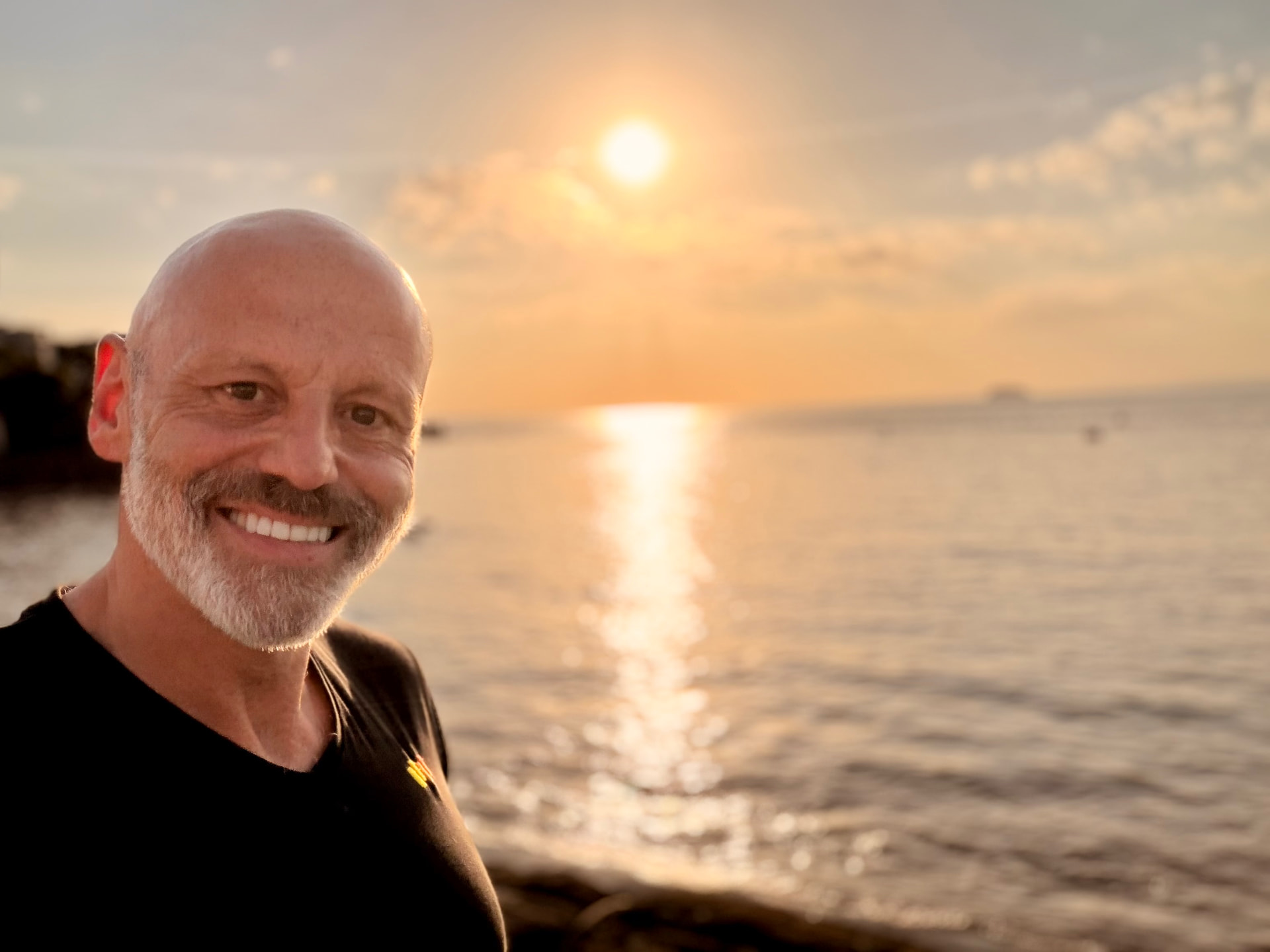 Brad Burton smiling beside the sea at sunset in Weston-super-Mare