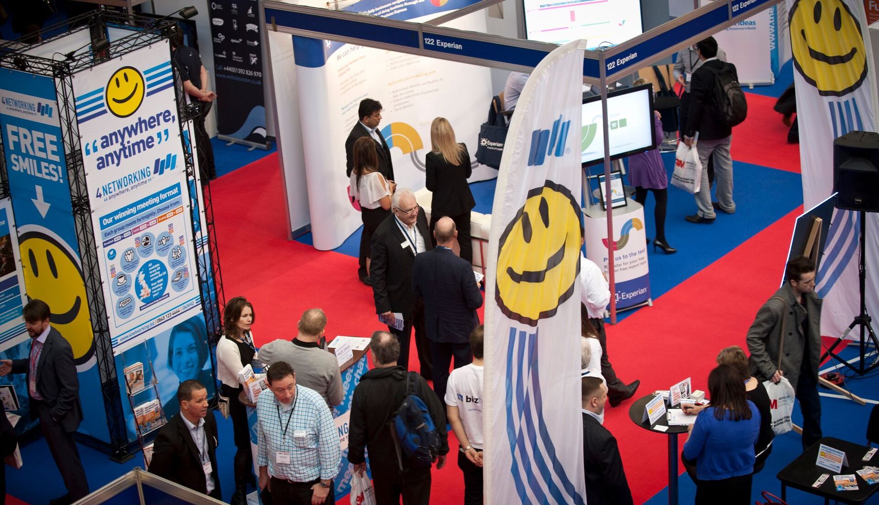 Aerial view of the 4Networking 'Free Smiles' exhibition stand at The Business Show, with members deep in 1-2-1 conversation on the red carpet