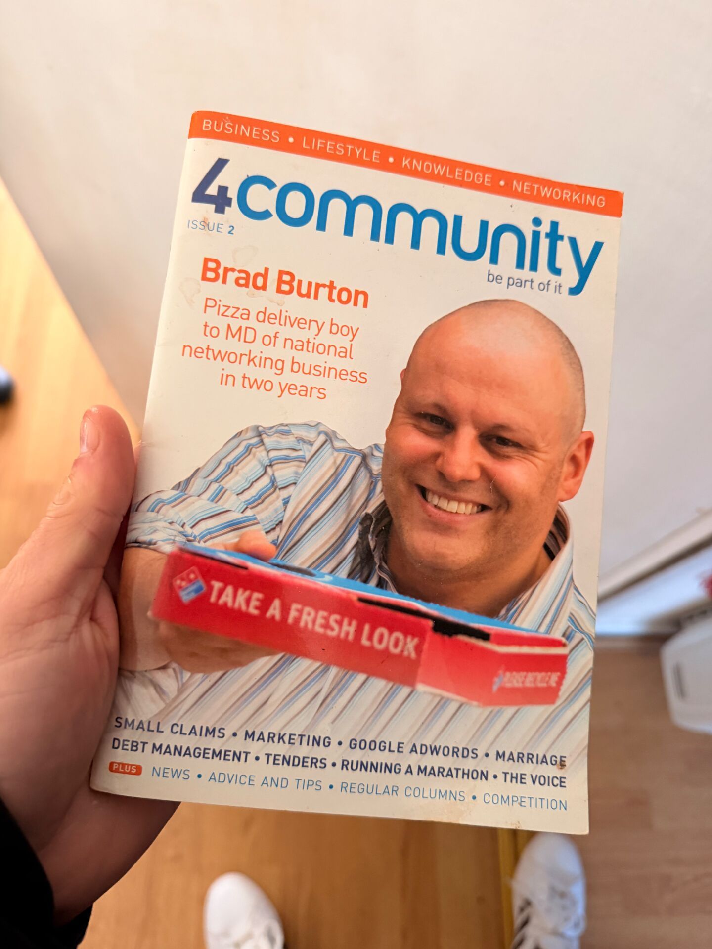 Early 4community magazine cover featuring Brad Burton with the headline 'Pizza delivery boy to MD of national networking business in two years'