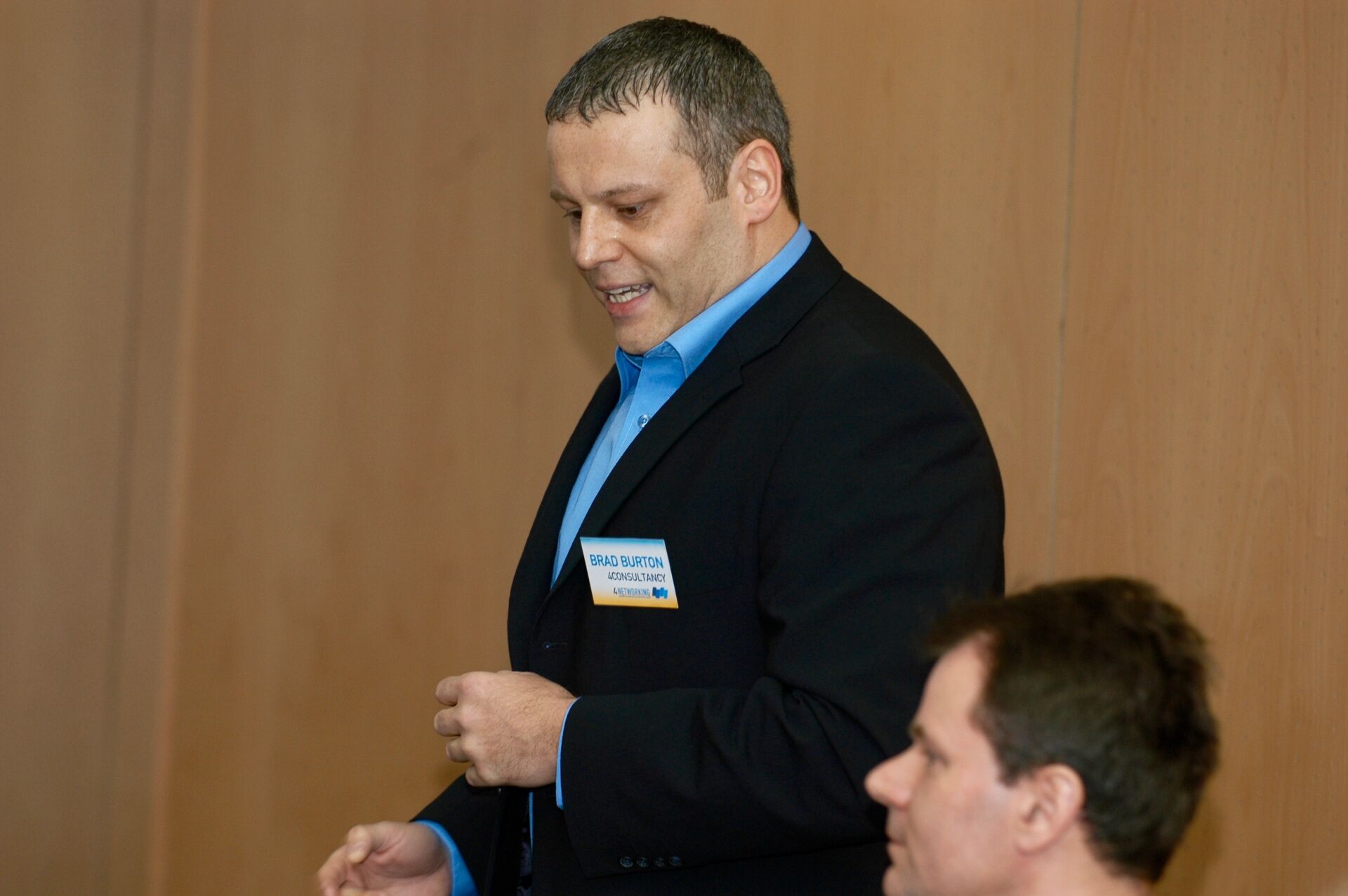 A young Brad Burton in jacket and blue shirt wearing a 4Consultancy / 4Networking name badge at one of the earliest meets