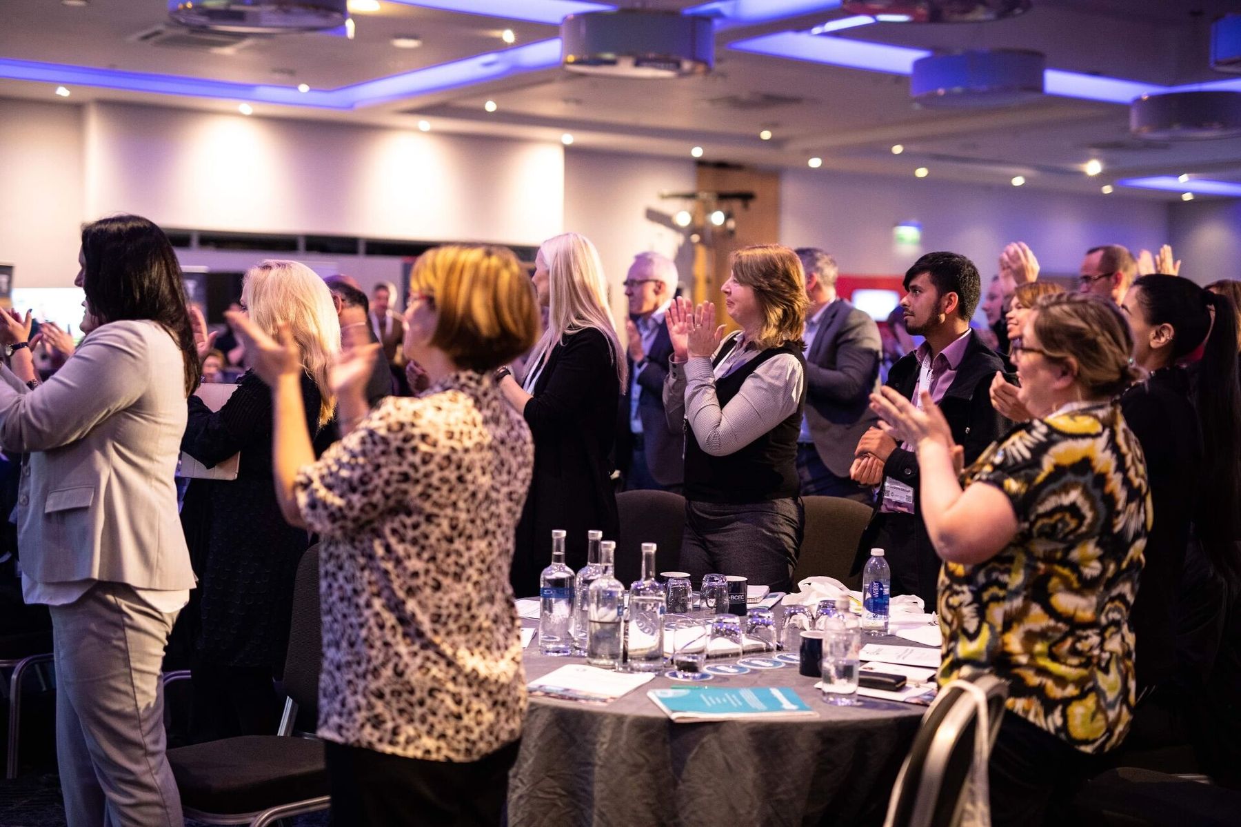 Conference audience on their feet, mid-applause, after a Brad Burton keynote